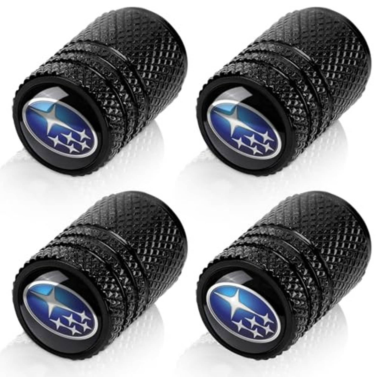 Four black textured tire valve stem caps with blue Subaru logo on round end covers.