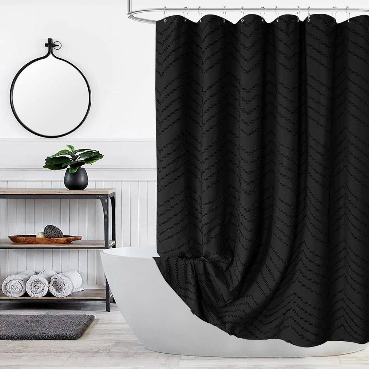 Black boho shower curtain with textured vertical chevron pattern, hanging from top rings