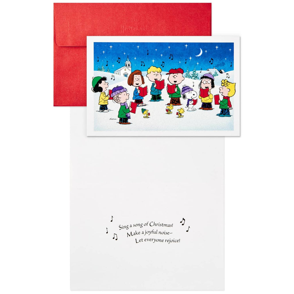Peanuts caroling holiday card with red envelope; inside panel shows printed Christmas verse