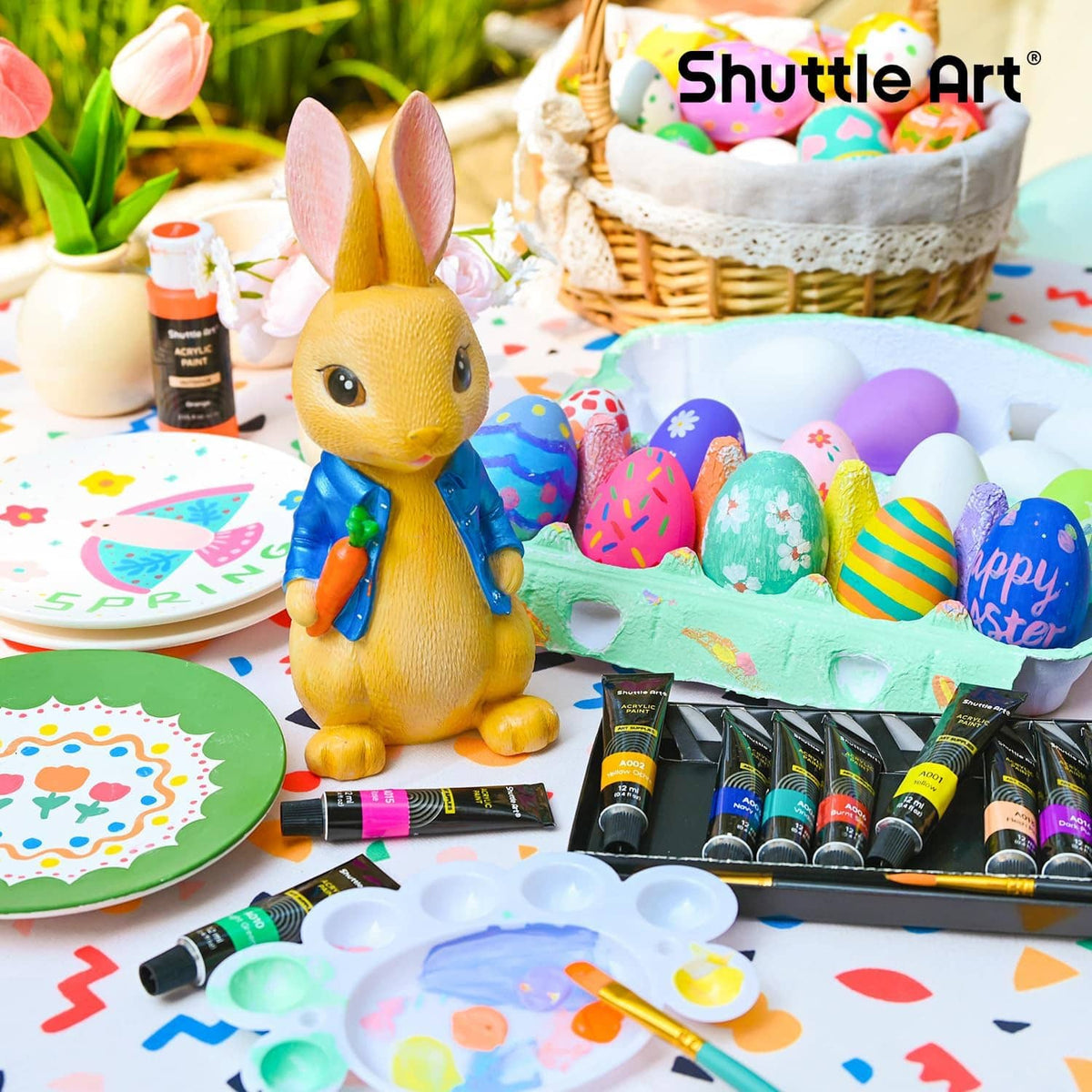 Acrylic paint set tubes and paintbrushes for crafting, arranged on a work surface