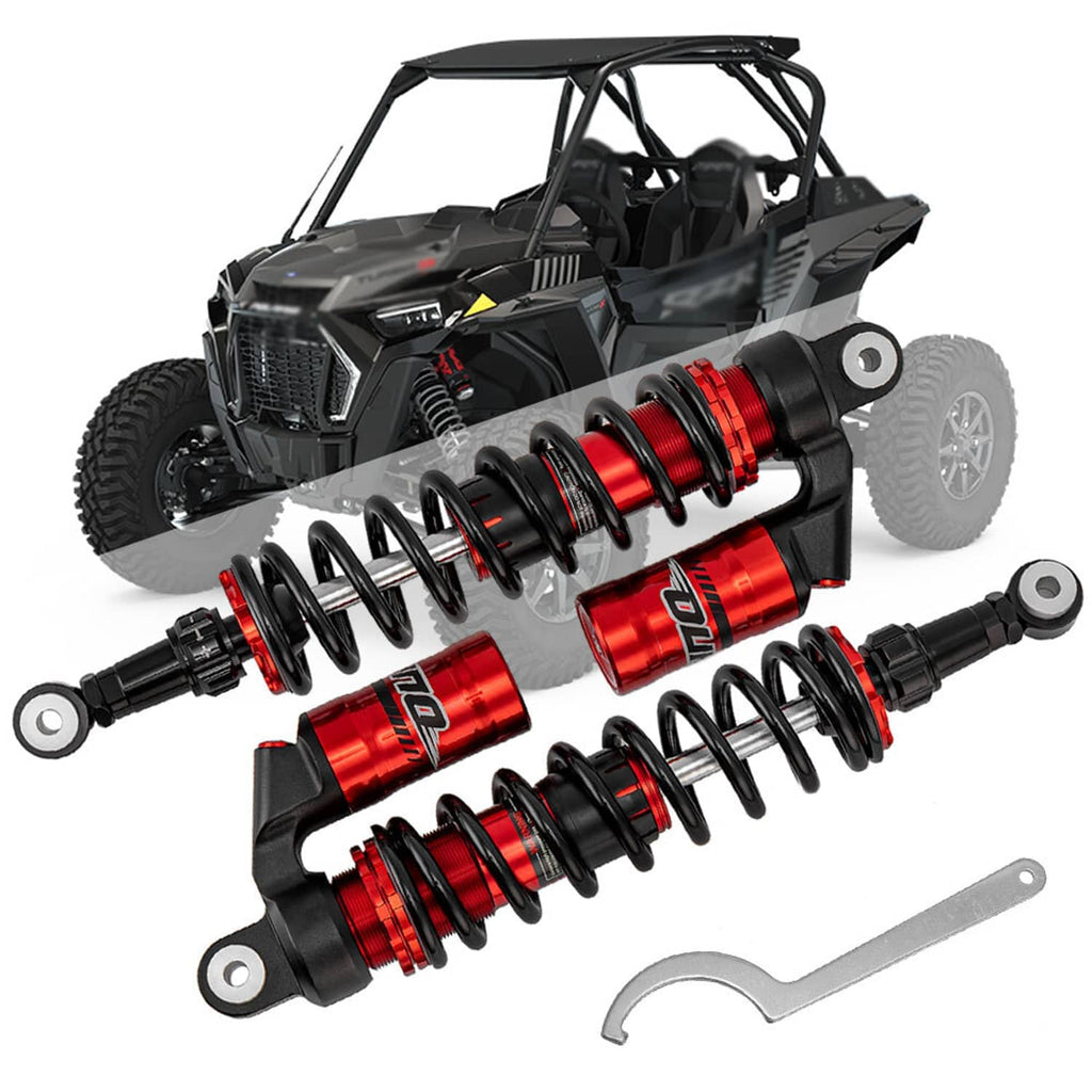Front coil-over shocks set with red reservoirs and black springs, shown on a UTV