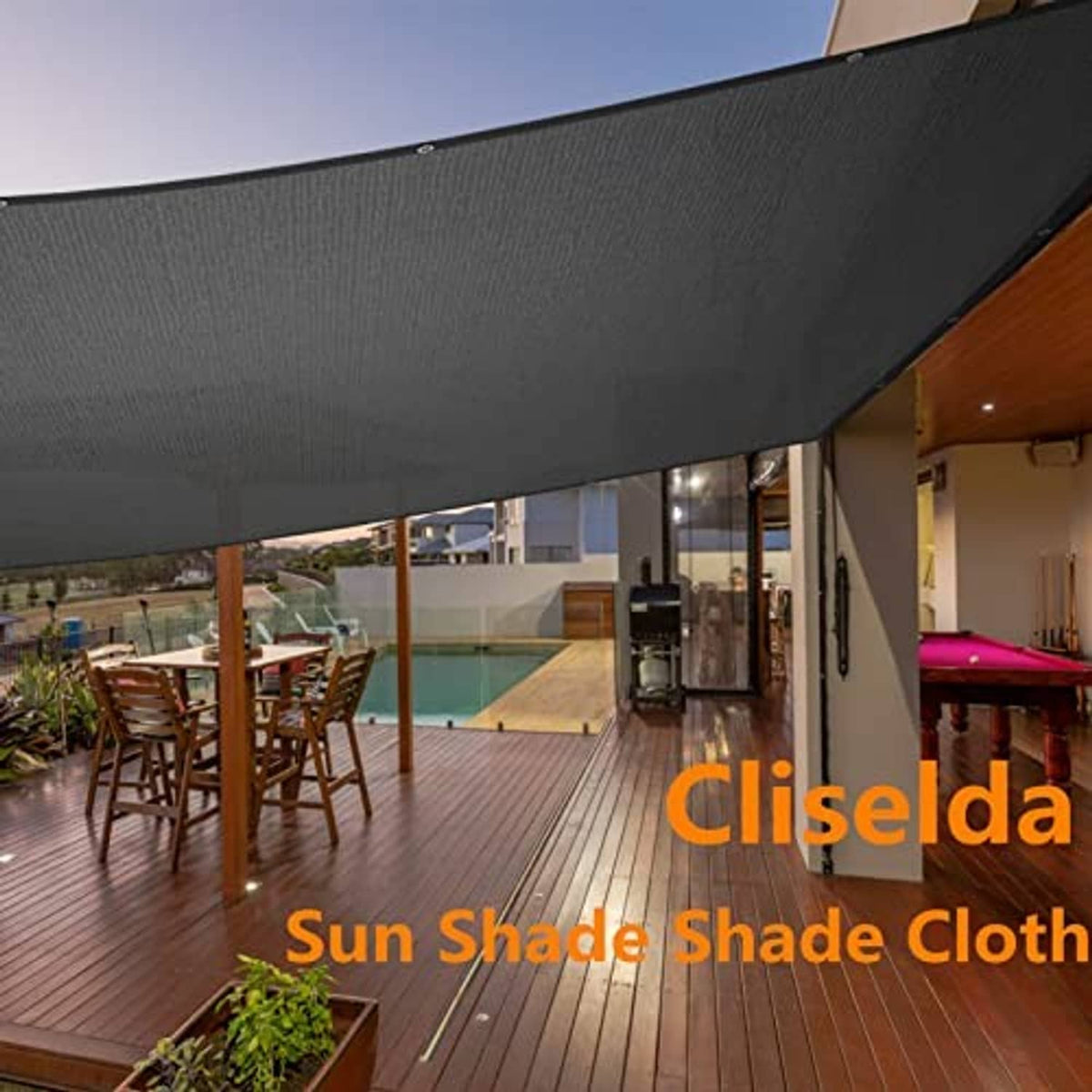 Black patio shade cloth canopy stretched over outdoor seating area