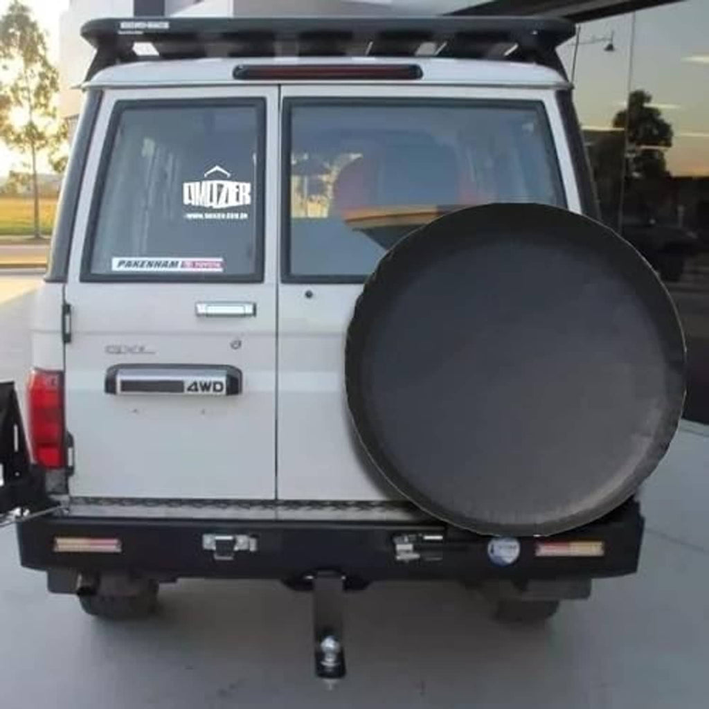 Universal spare tire cover installed on SUV rear, round dark gray/black cover