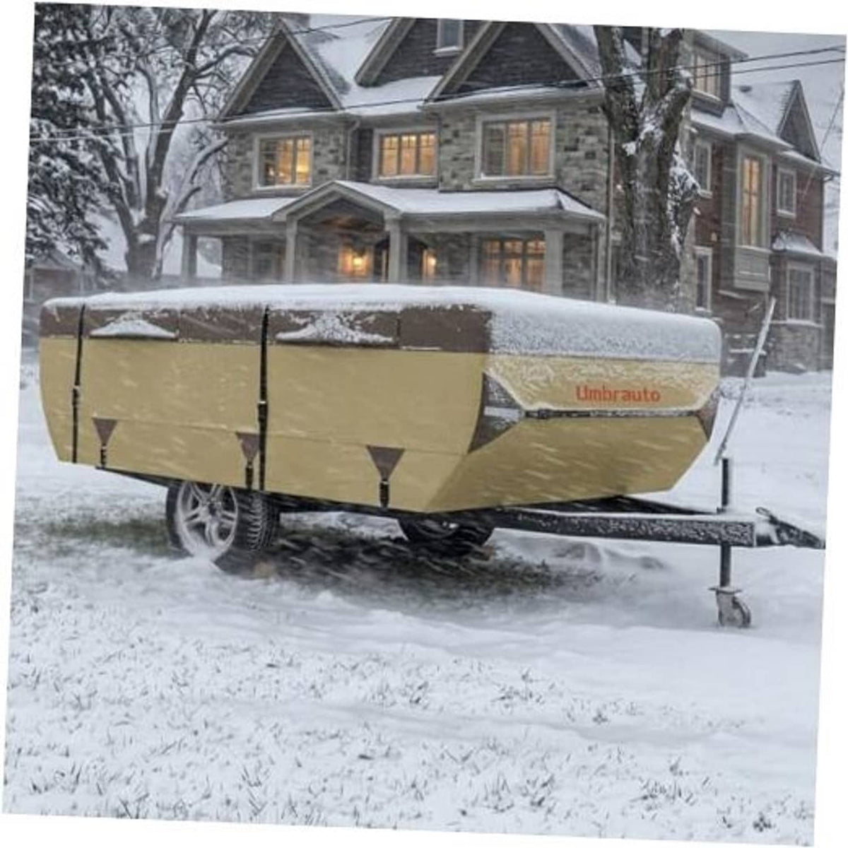 Pop-up camper cover in snowy conditions on trailer, tan fabric side straps