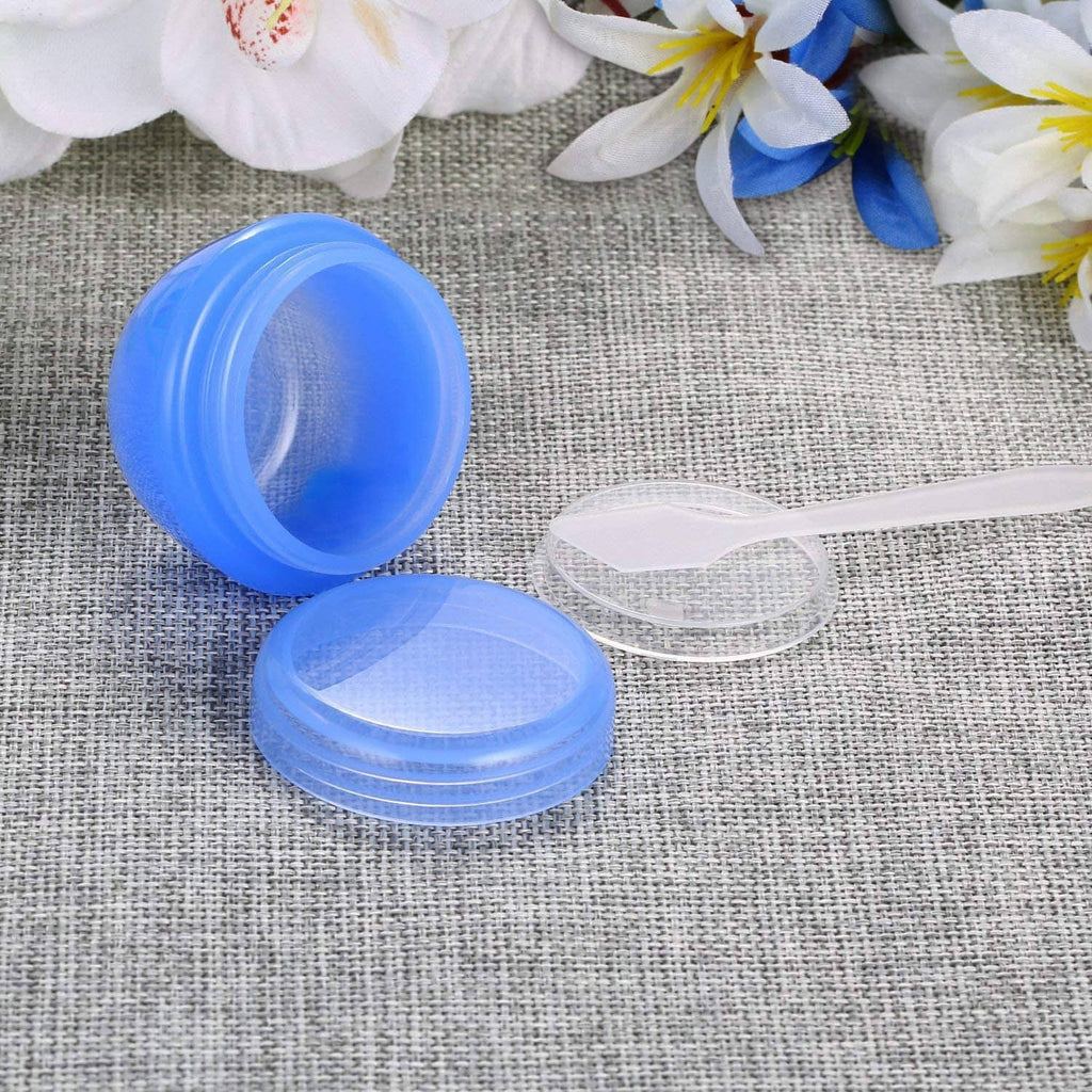 Blue 1 oz plastic toiletry jar with matching open lid on fabric surface