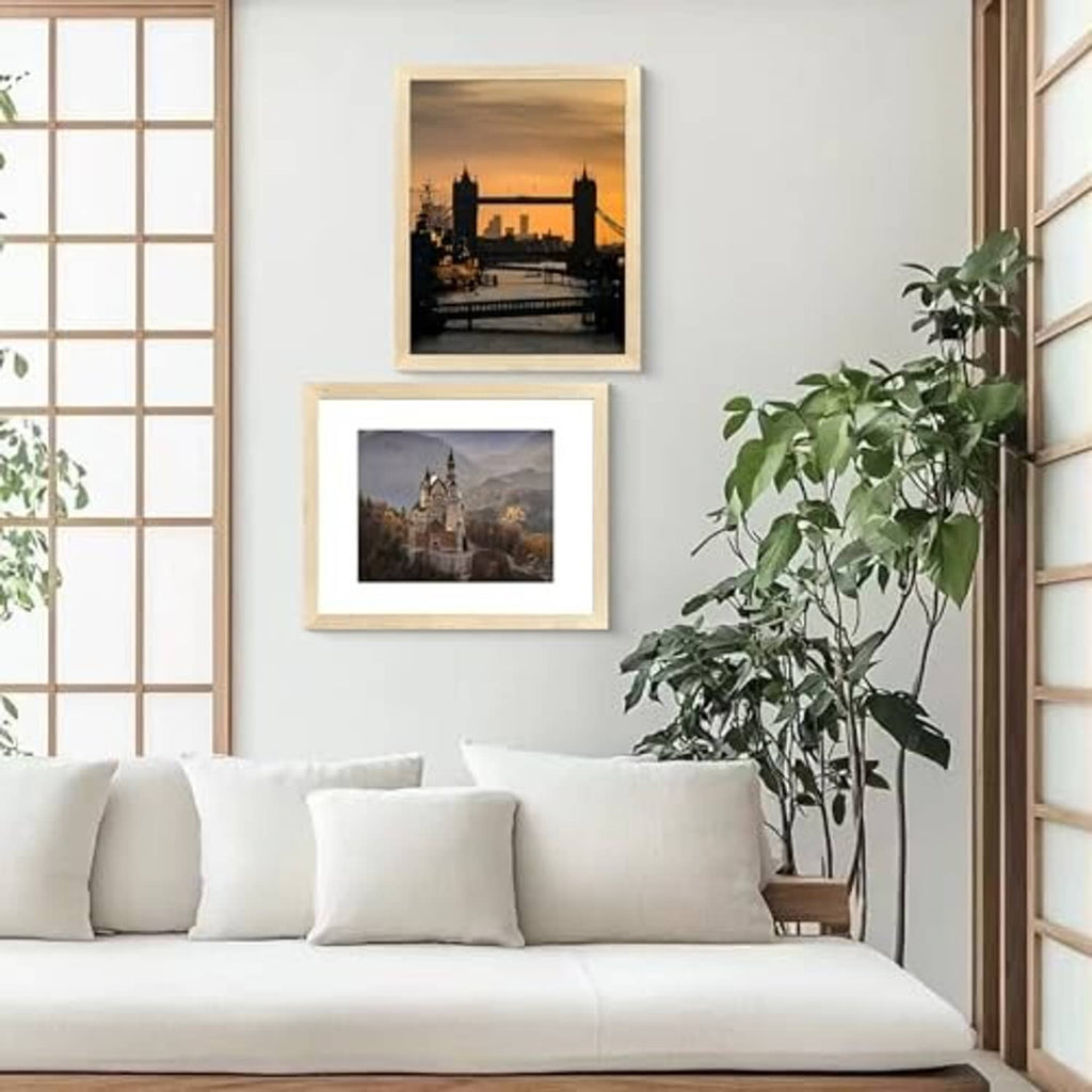 Natural wood wall picture frames with white mats and landscape photo inserts