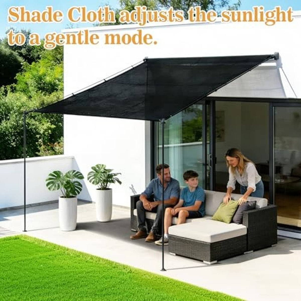 Black shade cloth canopy attached above patio seating with metal grommets