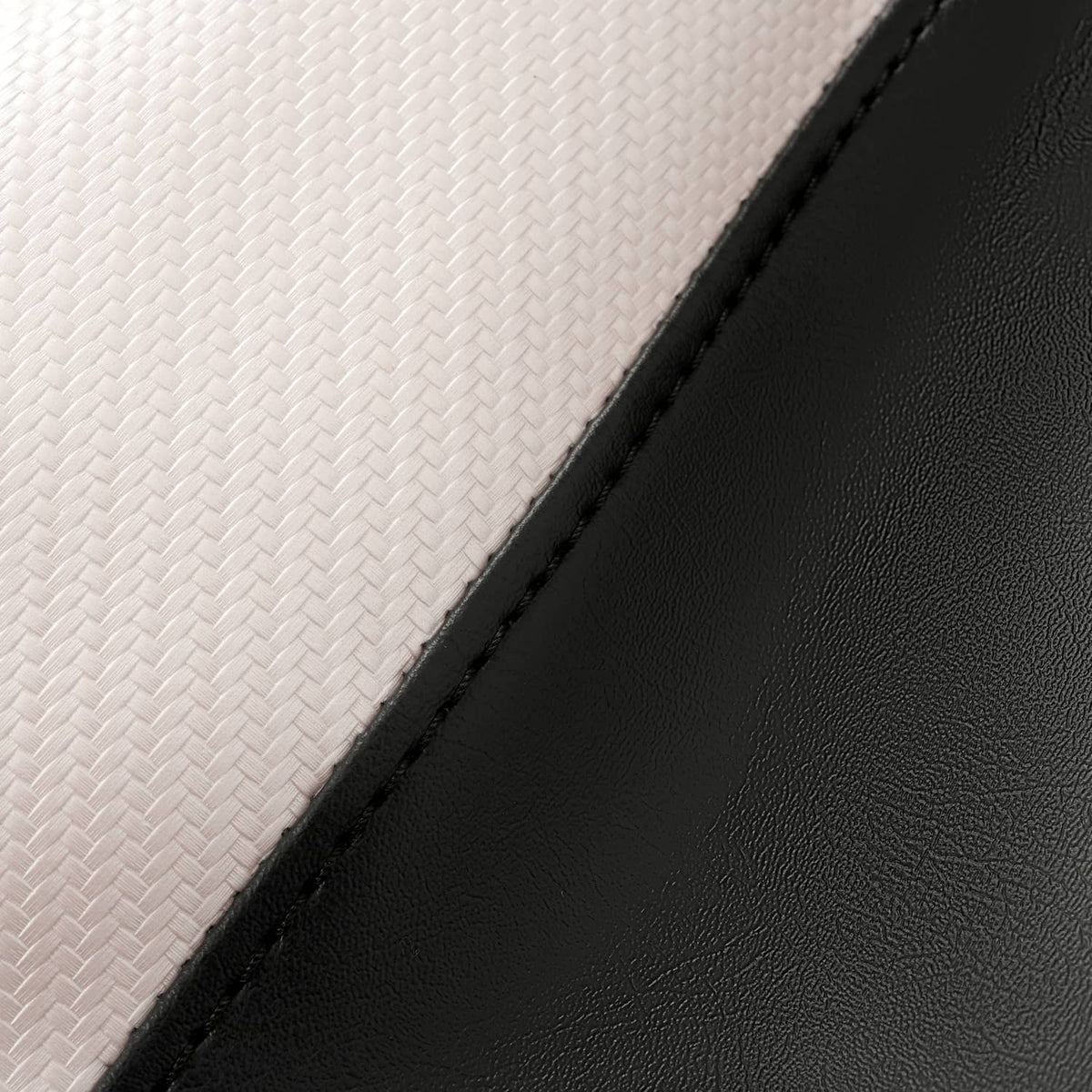 Seat cover fabric close-up, white textured weave with black edge and stitched seam