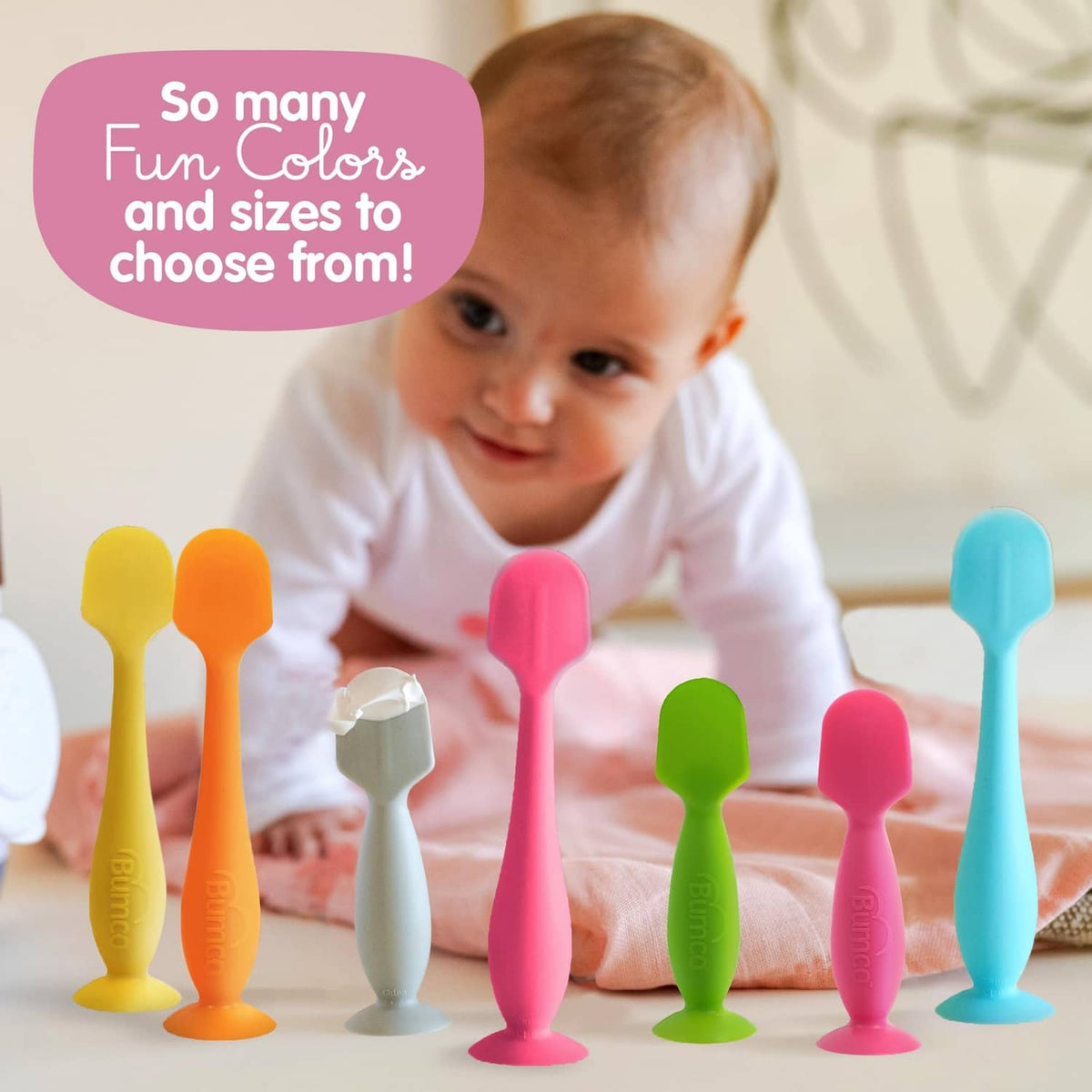 Pink baby bum brush with suction base and soft flexible silicone bristles