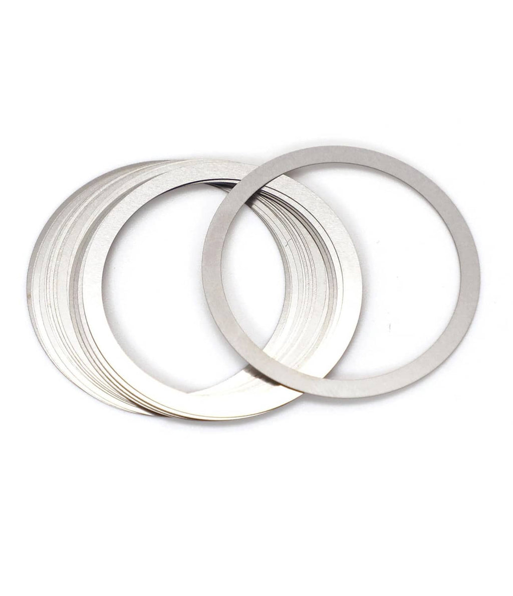 Silver barrel nut shim rings, multiple flat metal shims stacked and loose