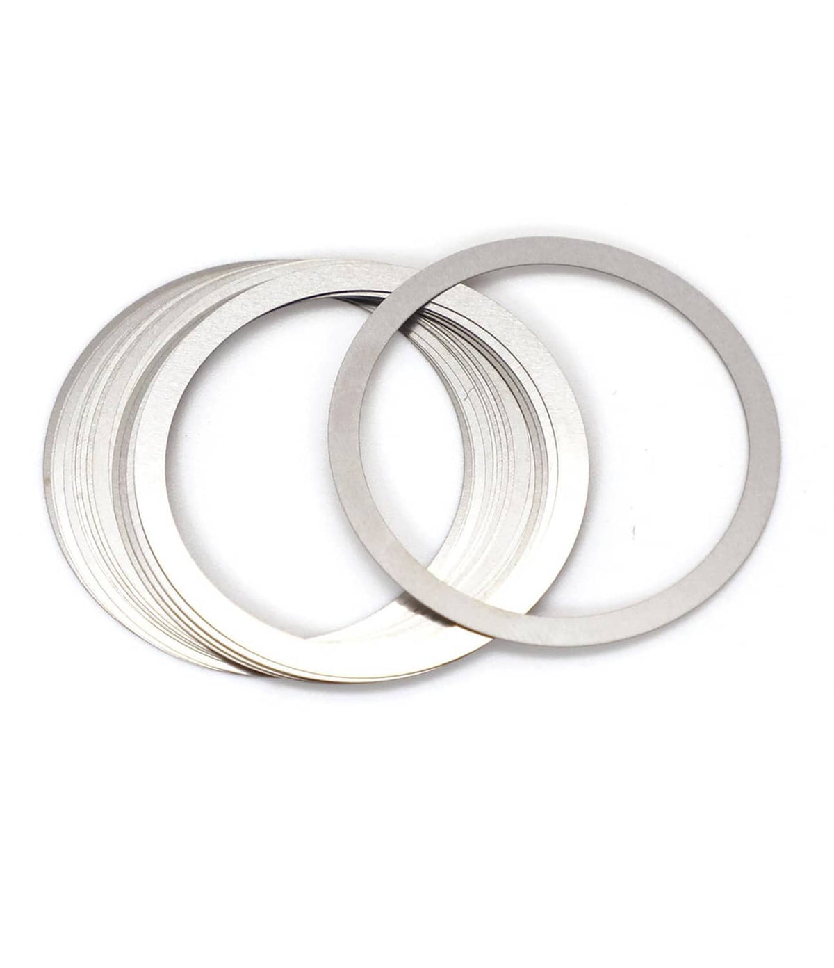 Silver barrel nut shim rings, multiple flat metal shims stacked and loose