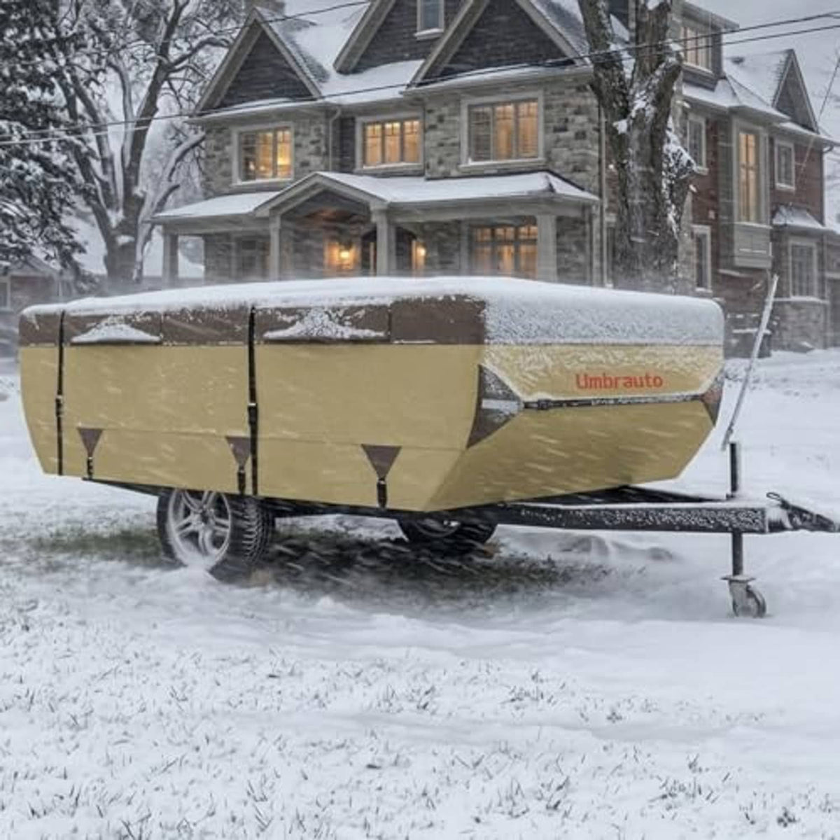 Pop-up camper cover in snow on a trailer, tan fabric with tie straps