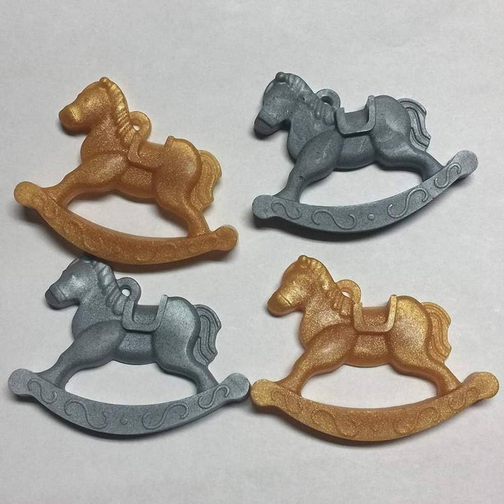 Set of four rocking horse candies in gold and gray colors.