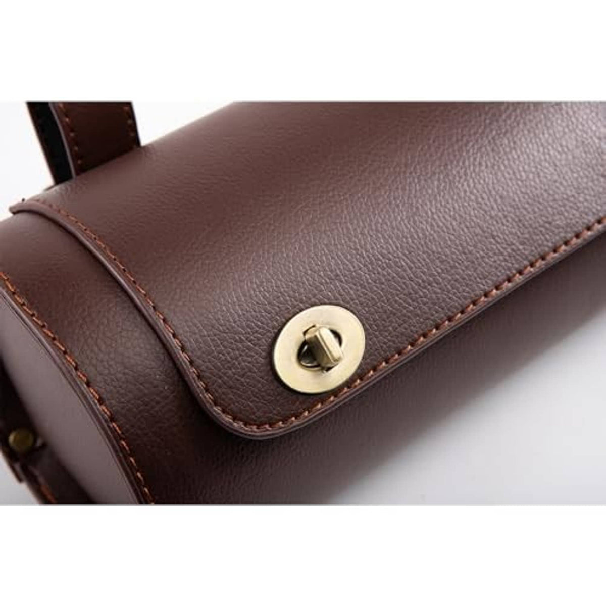 Brown leather-look mini tool bag close-up of gold snap and stitched trim