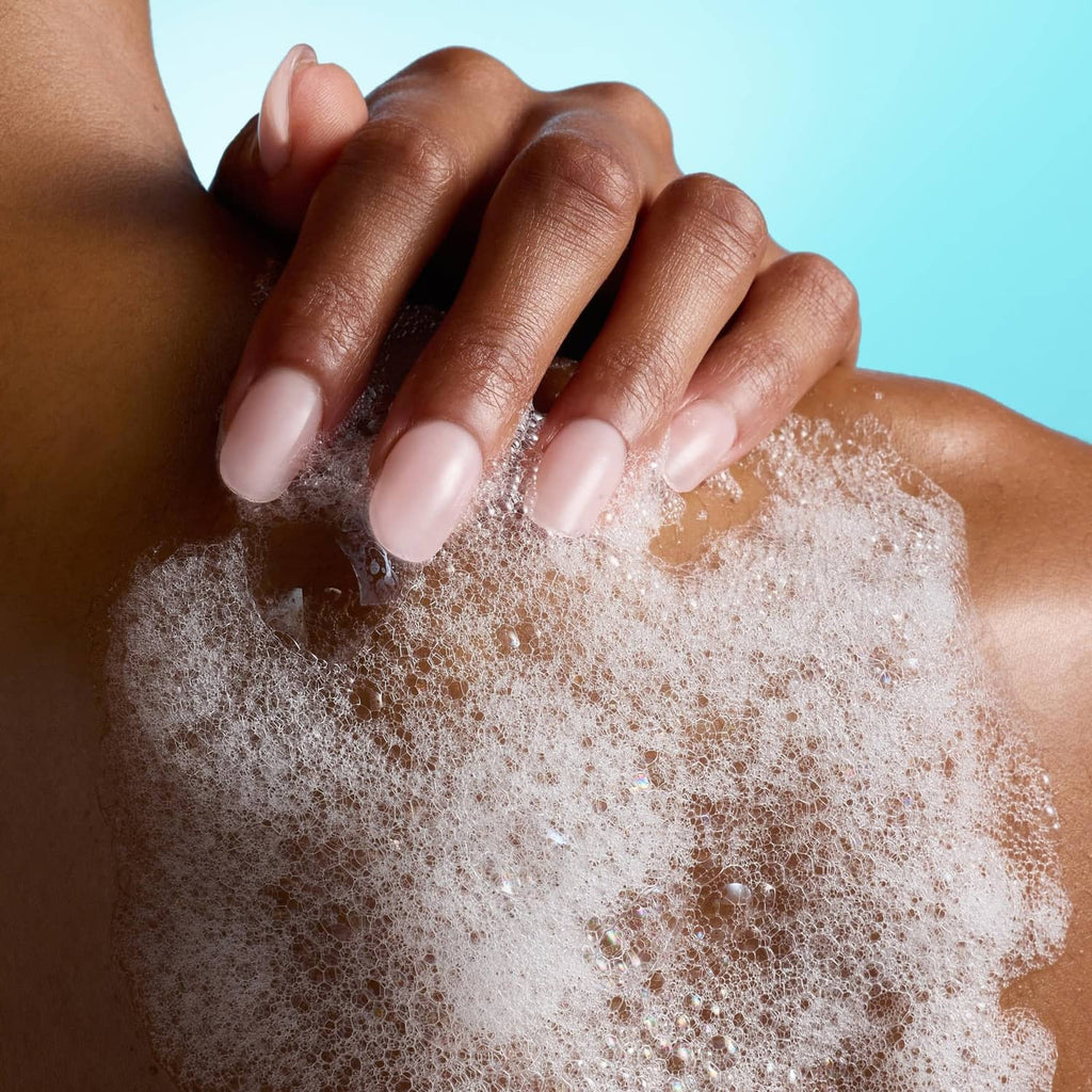 Foaming gel body wash lather and bubbles on fingertips