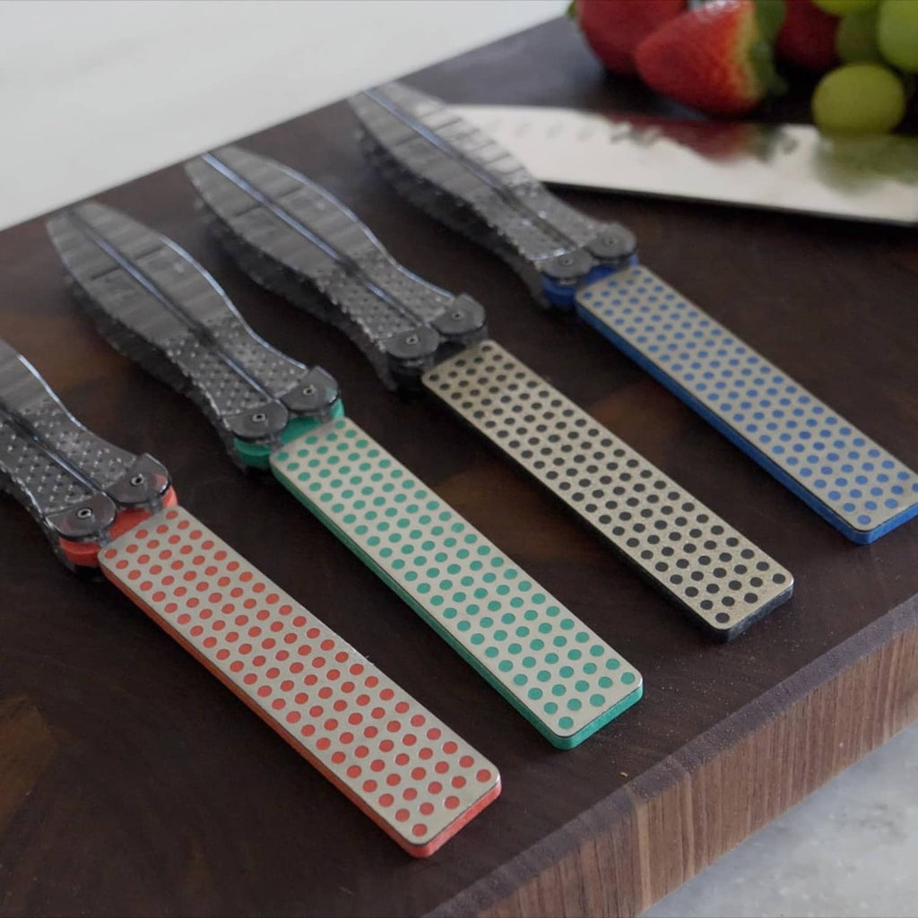 Assorted color portable sharpening stones with dotted pads and folding guides