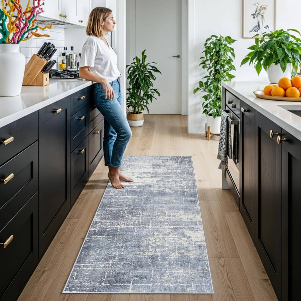 Blue and ivory rectangular entryway runner rug on wood floor in a kitchen.