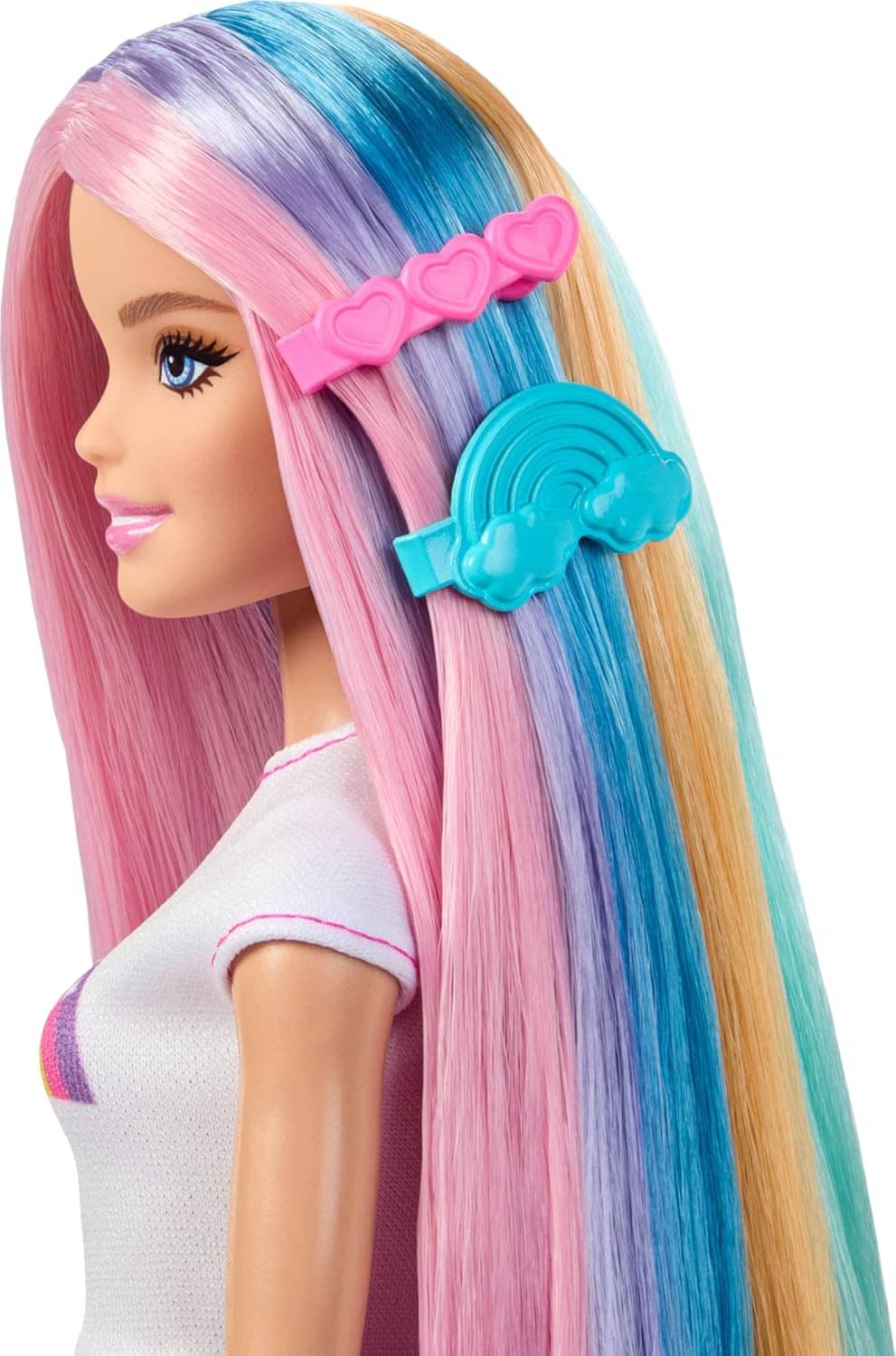 Rainbow hair doll close-up with pastel pink, blue, and blonde hair and a pink heart clip.