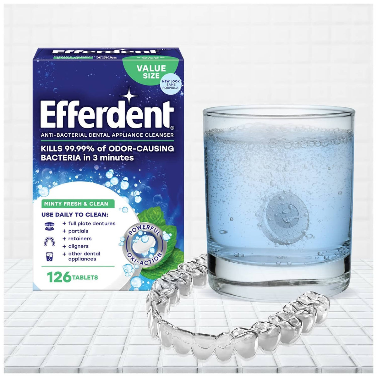 Efferdent tablets box with glass of cleaning solution and metal denture retainer