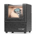 Black single watch winder with open window and beige plush pillow, holding a wristwatch