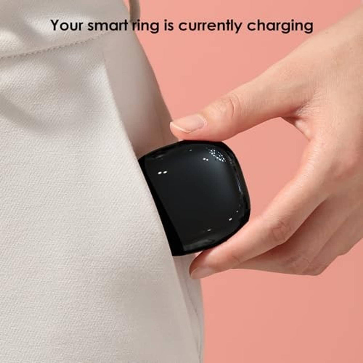 Black charging case with gold charging pad, held in hand near fabric