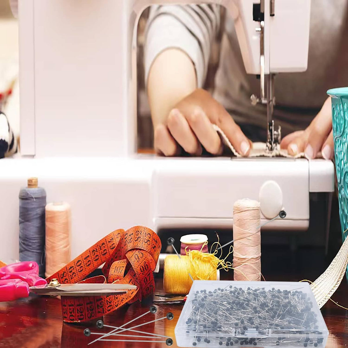 Straight sewing pins with black ball heads scattered near a sewing machine