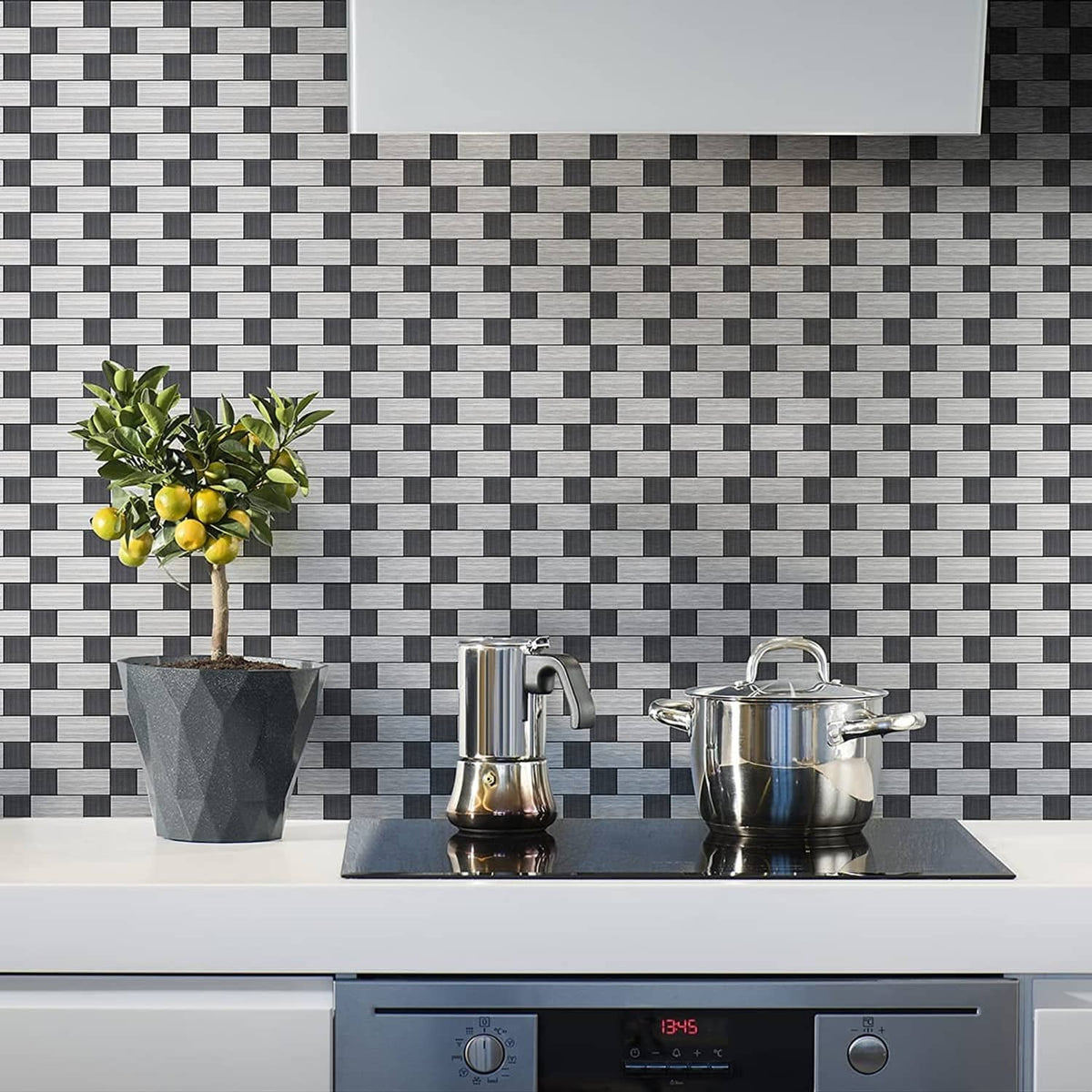 Gray and white metal backsplash tiles in a small square brick mosaic pattern