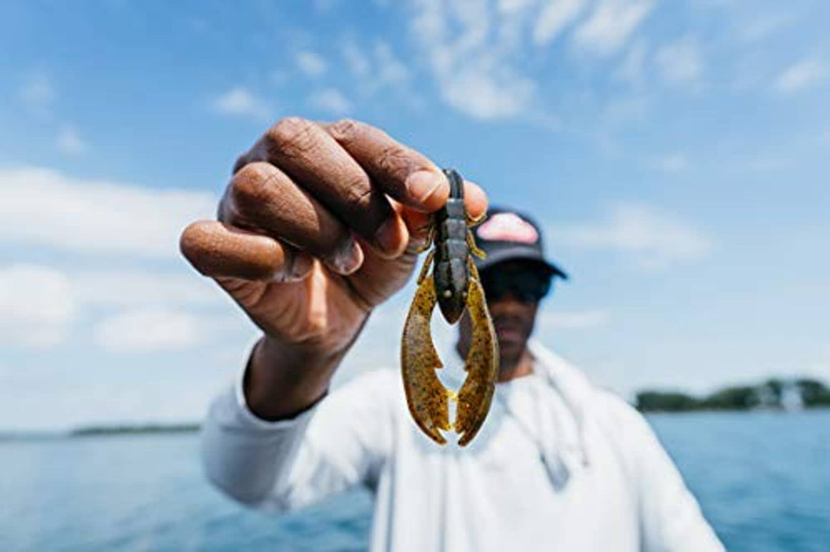 Lime green craw lure with dark speckles held up by a fisherman