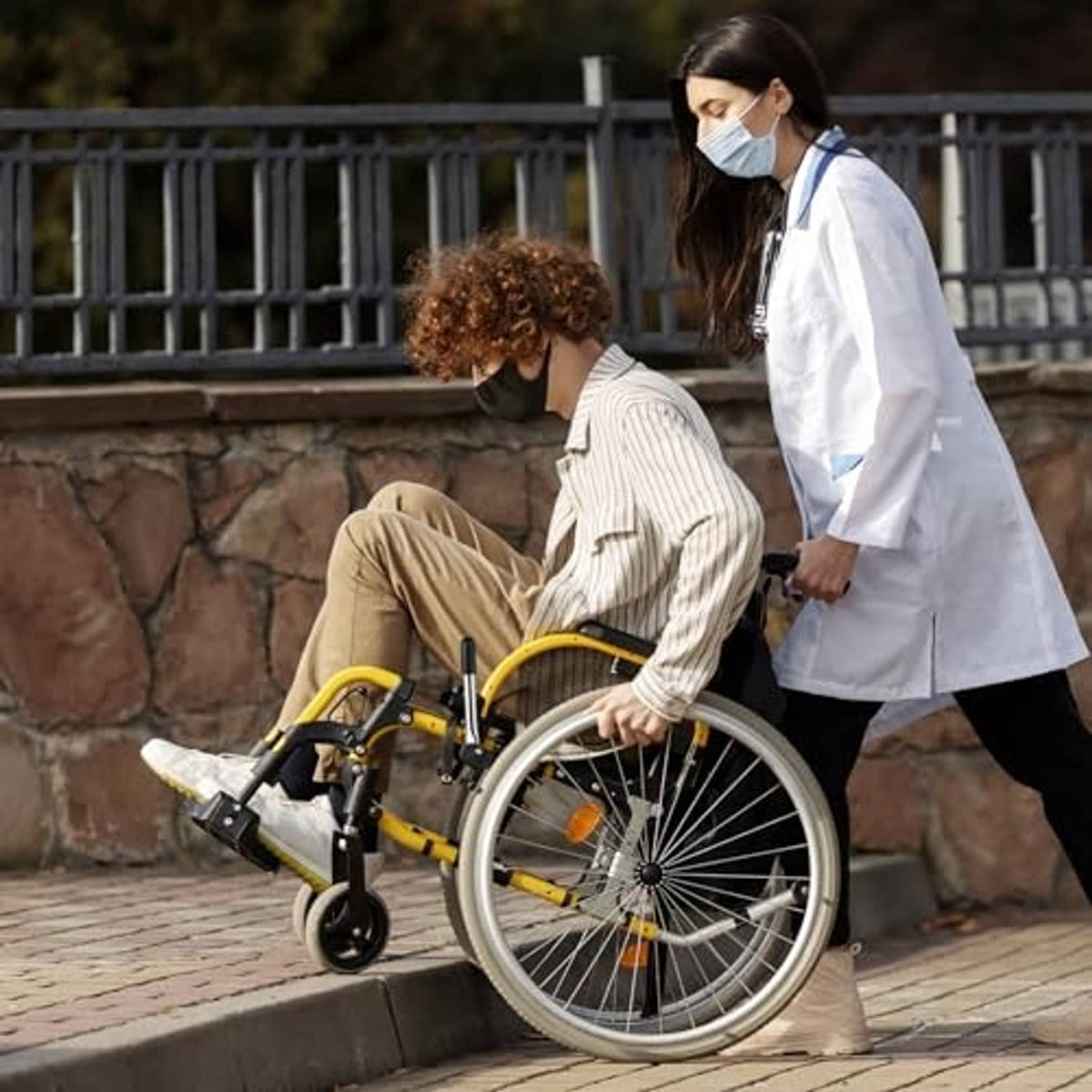 Wheelchair brake lever extender on silver bar with black rubber end cap