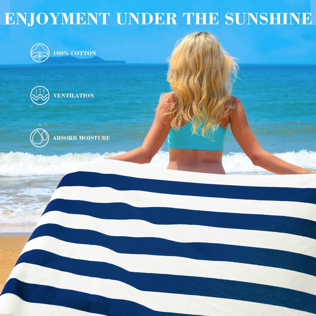 Oversized navy and white striped cotton beach towel spread out