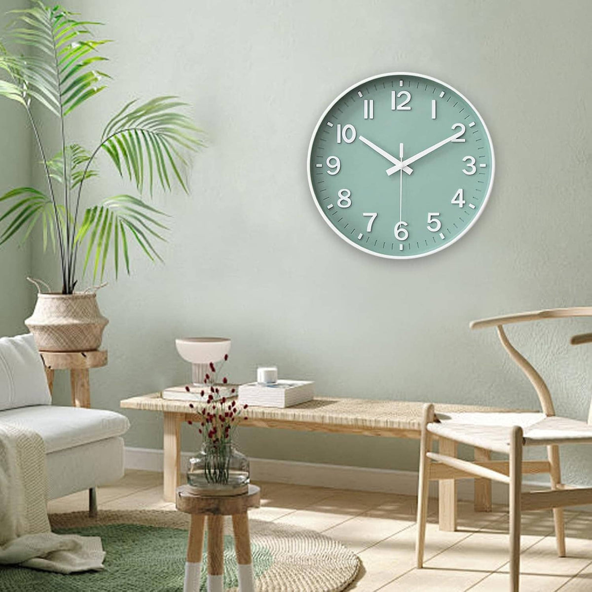 Green round wall clock with white hands and numerals on a light-colored living room wall.