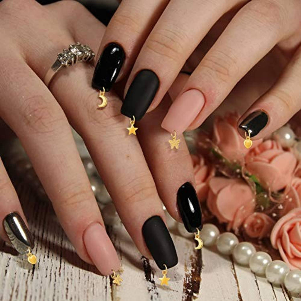 Nail jewelry rings on black and nude nails with gold crescent and star charms