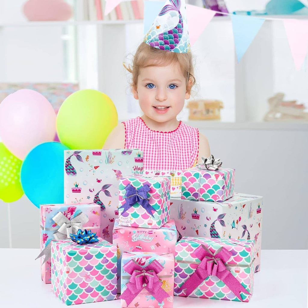 Girl at birthday holding gifts wrapped in mermaid-scale wrapping paper