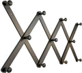 Wooden accordion wall hat rack with dark round knob hooks in zigzag pattern