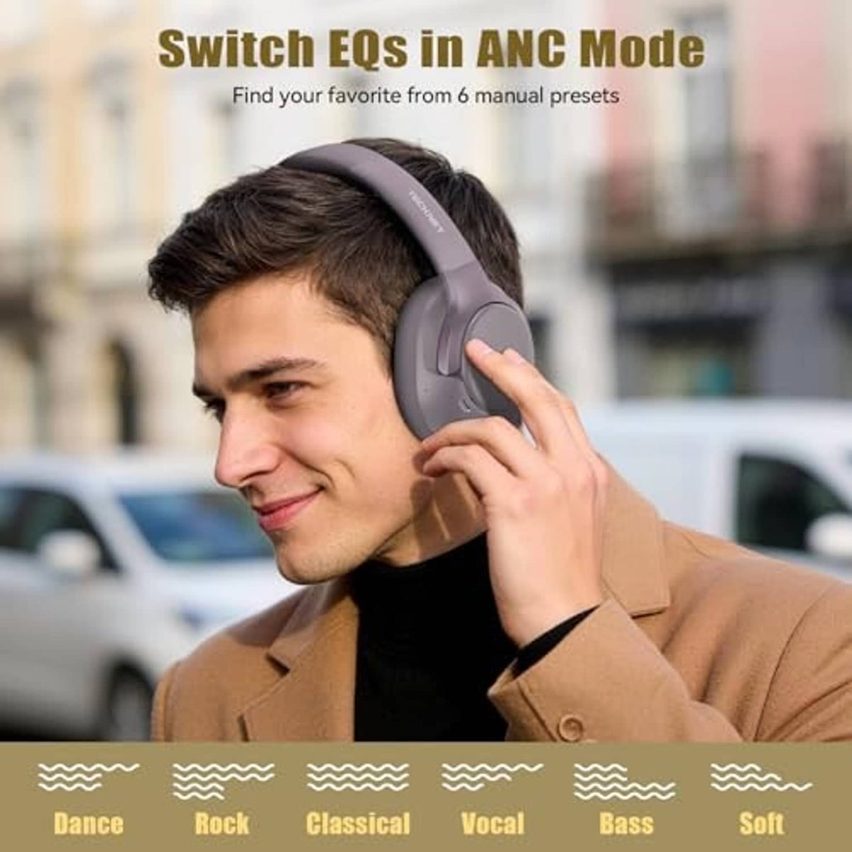 Gray over-ear headphones worn on a person, cushioned ear cups and adjustable fit