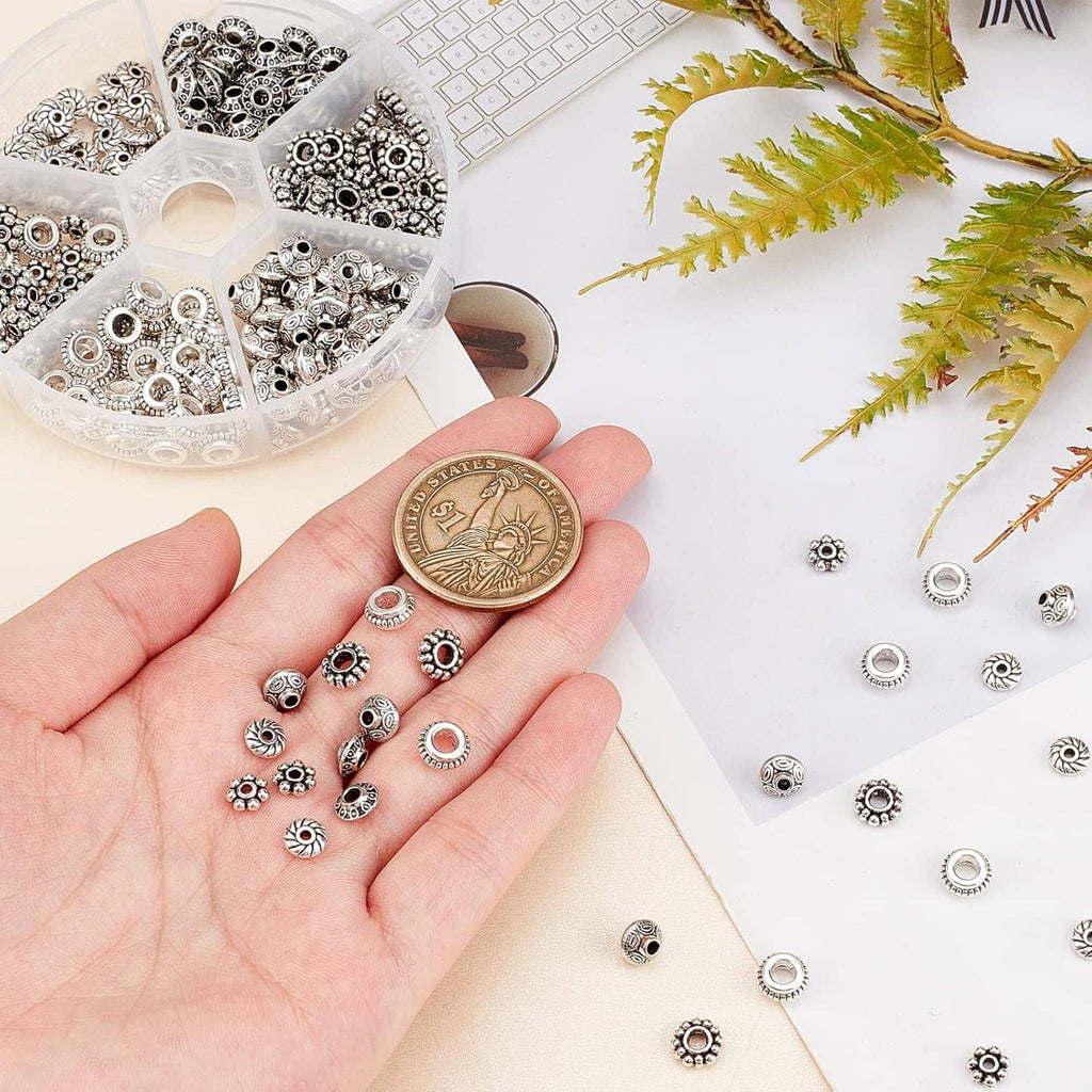 Bulk pack of antique silver spacer beads with textured circular and tube bead caps