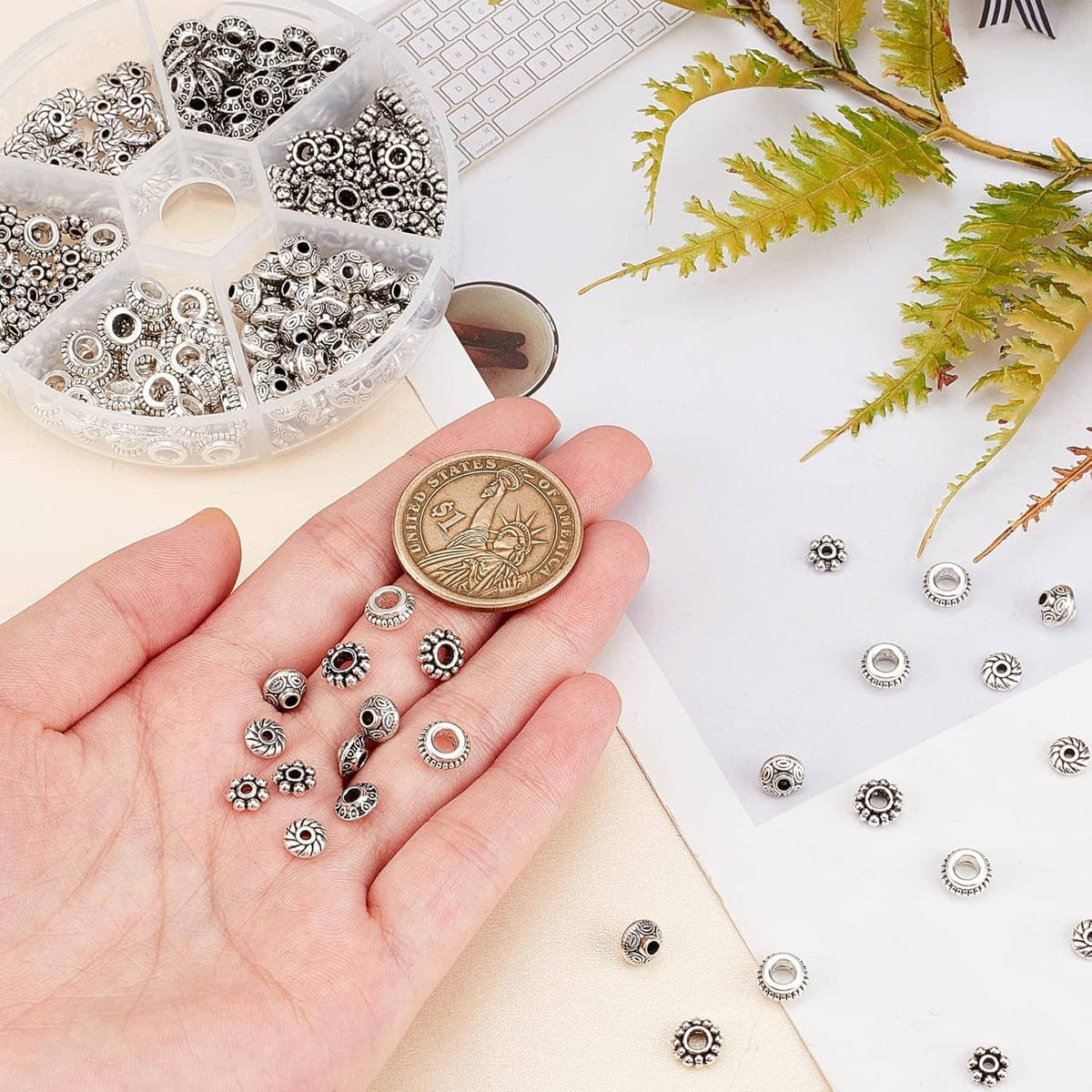 Bulk pack of antique silver spacer beads with textured circular and tube bead caps