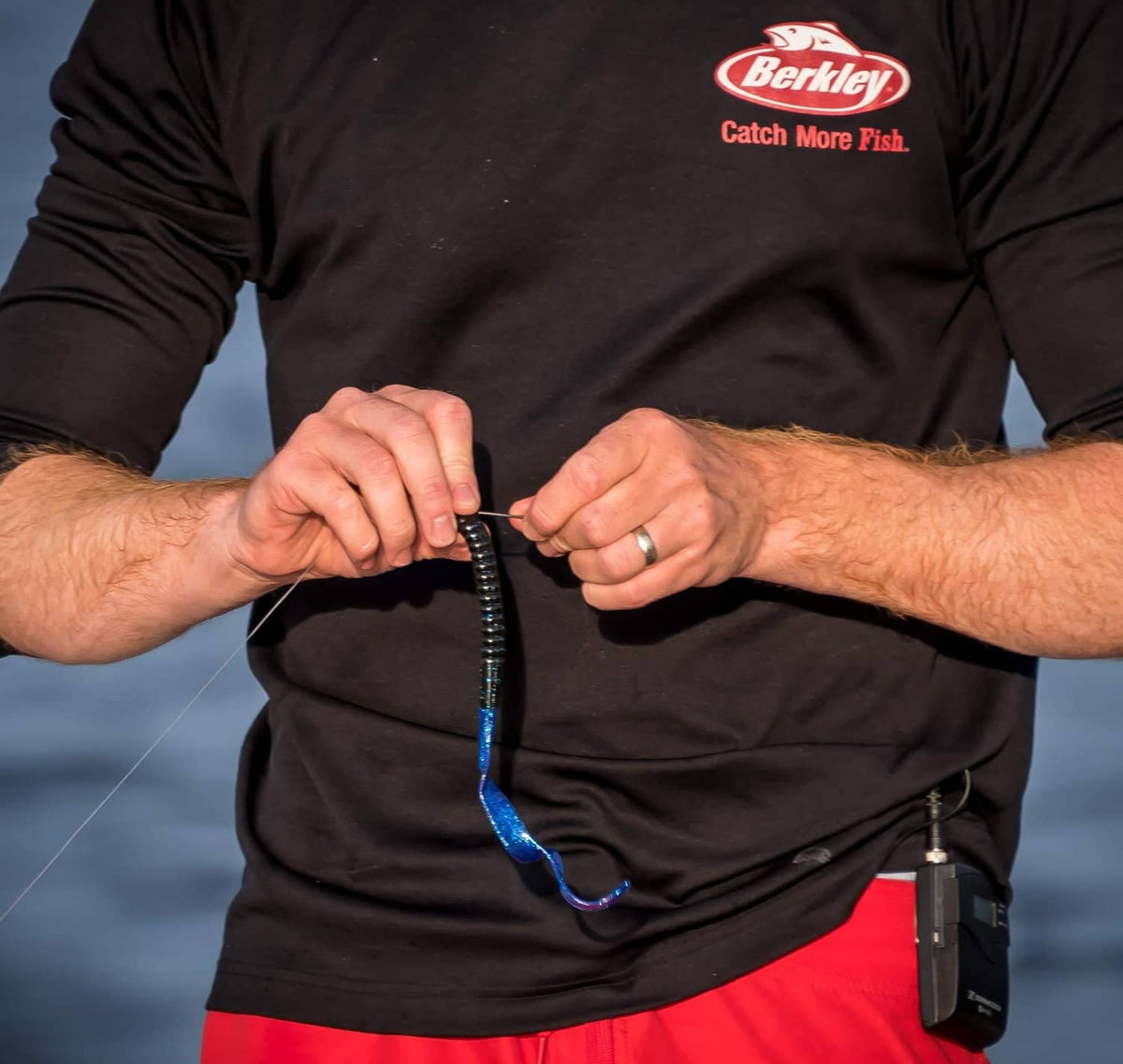 Curly-tail soft plastic worm bait attached to a fishing hook