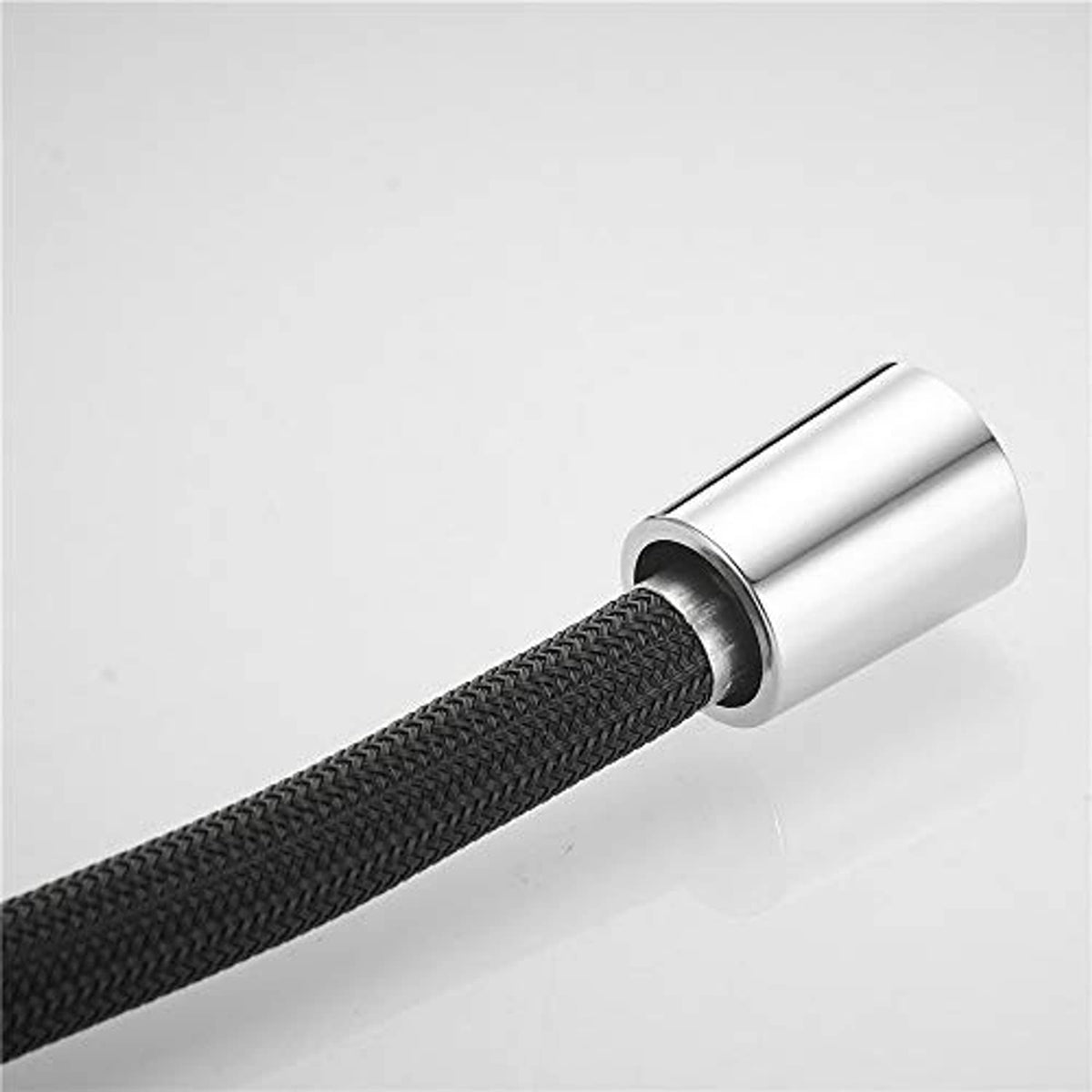 Chrome sleeve connector on black braided pull-down faucet hose, with inner hose opening.