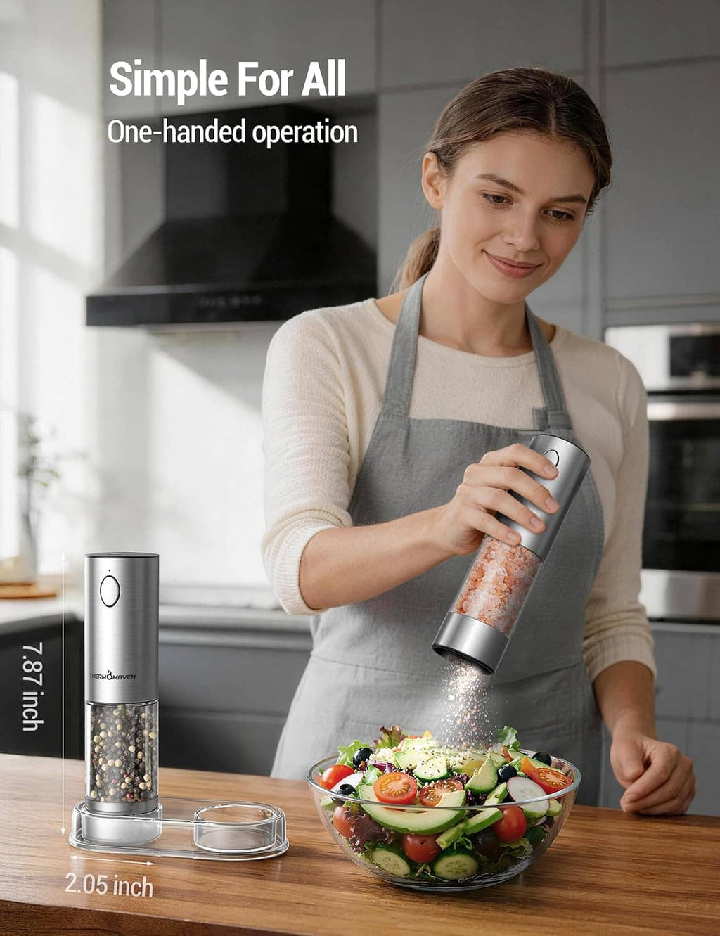 Stainless THERMOMAVEN electric salt and pepper grinder used one-handed over a bowl