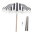 Black-and-white striped patio umbrella with white tassel fringe and wooden pole