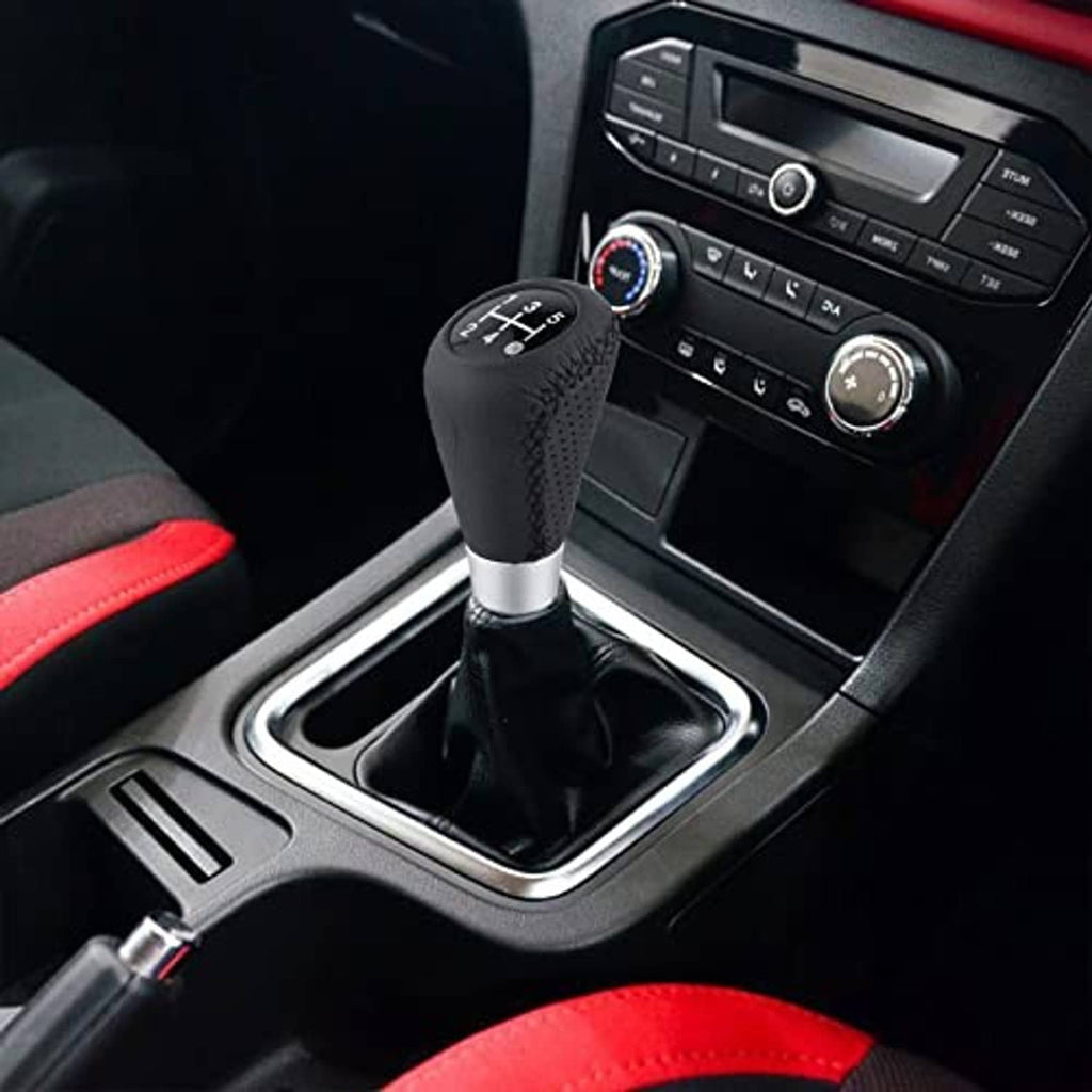 Black leather shift knob with silver base, textured grip, and visible stitched seam