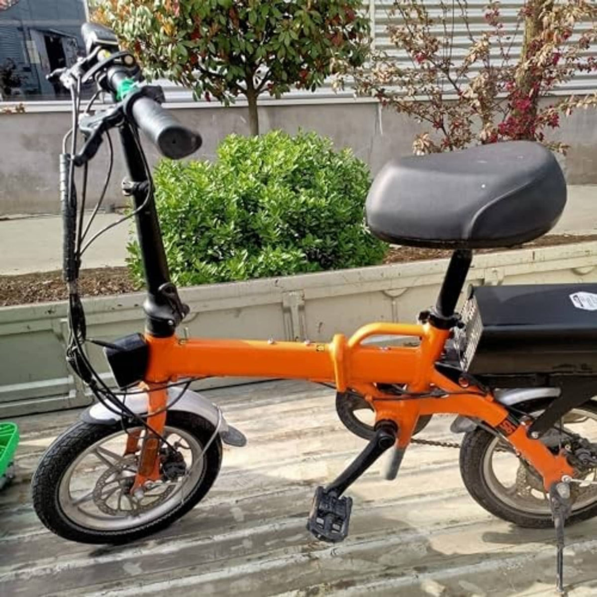 Orange kids bike with black front wheel tire and inner tube installed