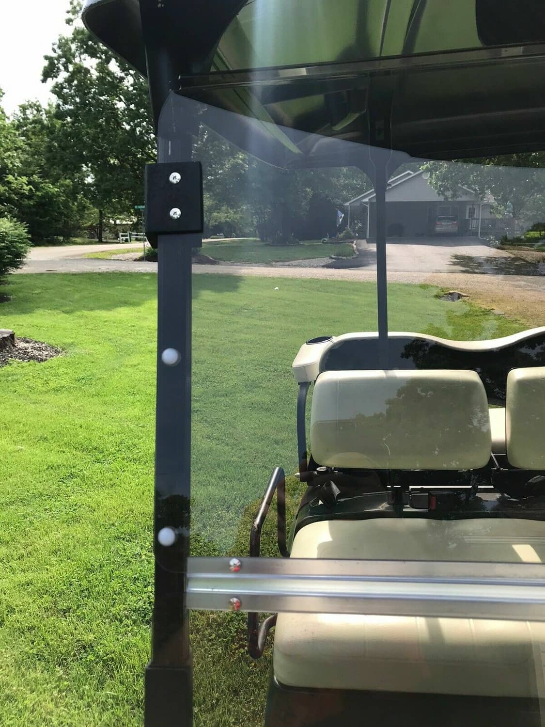 Tinted folding windshield front view with mounting posts and clear tinted glass