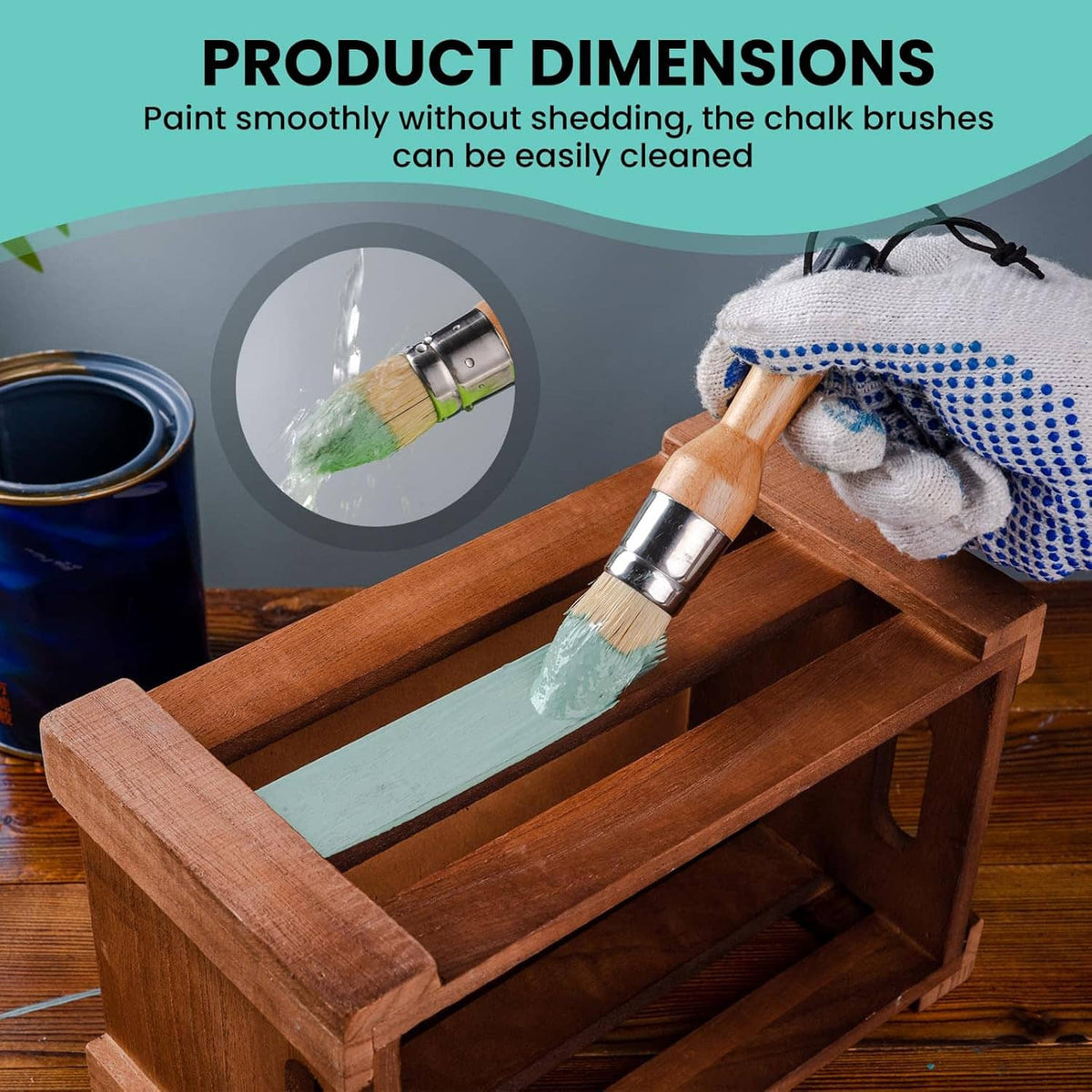 Wax paint brush with light wood handle and beige bristles resting on wooden tray