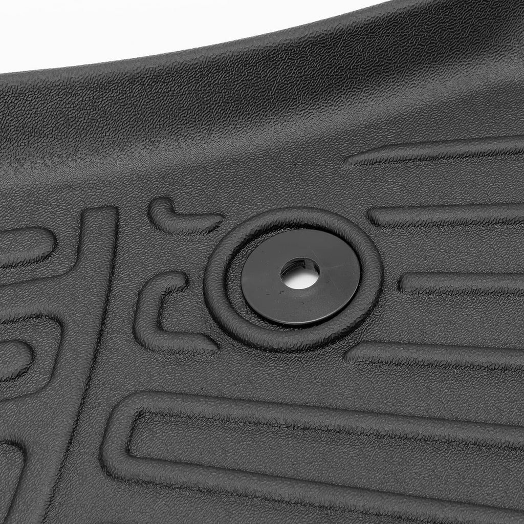 Close-up black floor mat liner with circular anchor hole and surrounding channels