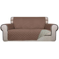 Reversible quilted sofa cover with brown top and beige underside, fitted for loveseat