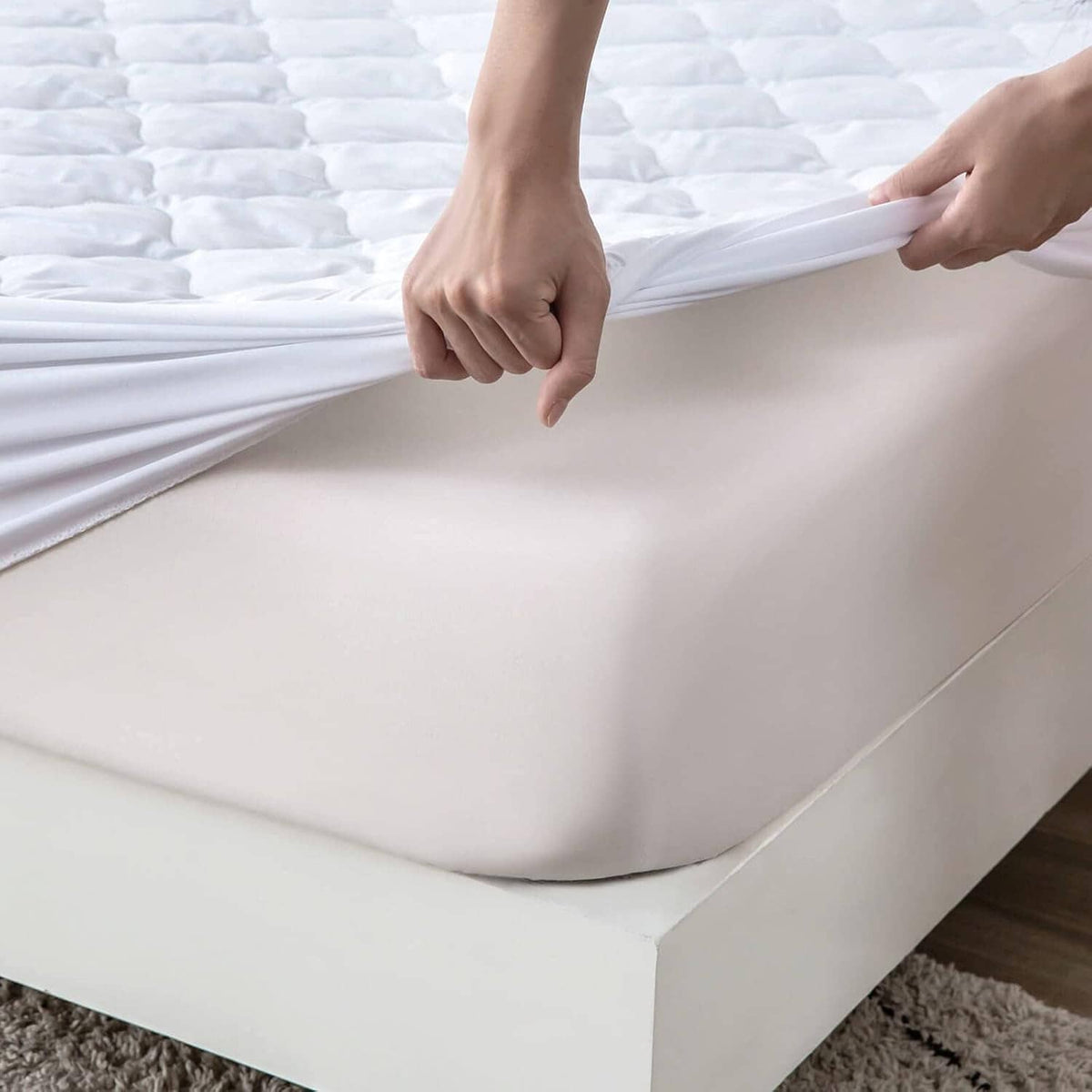 Waterproof mattress protector pad, white fitted sheet with elastic edge and folds