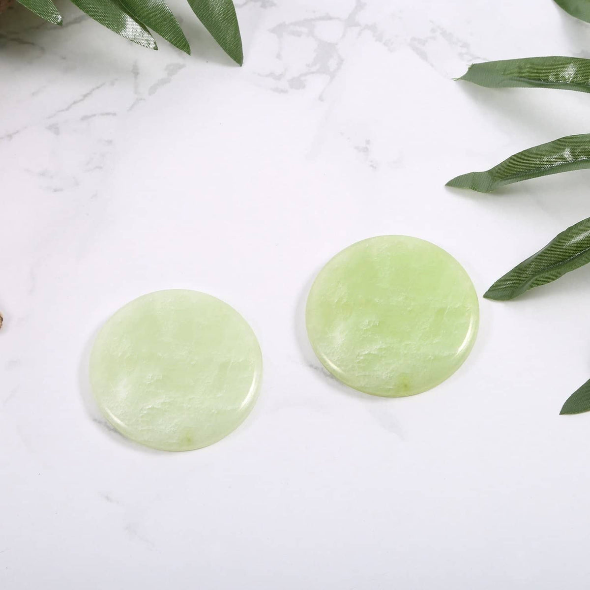 Two small round light green jade stones for eyelash glue