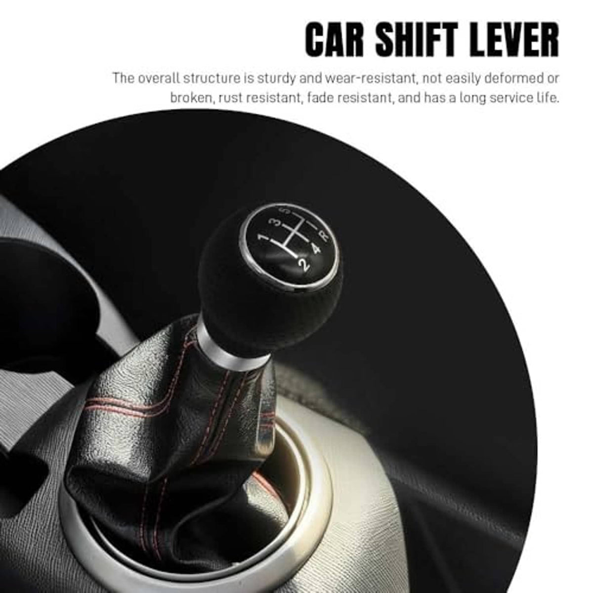 Black round gear shift knob with silver trim on leather shifter boot